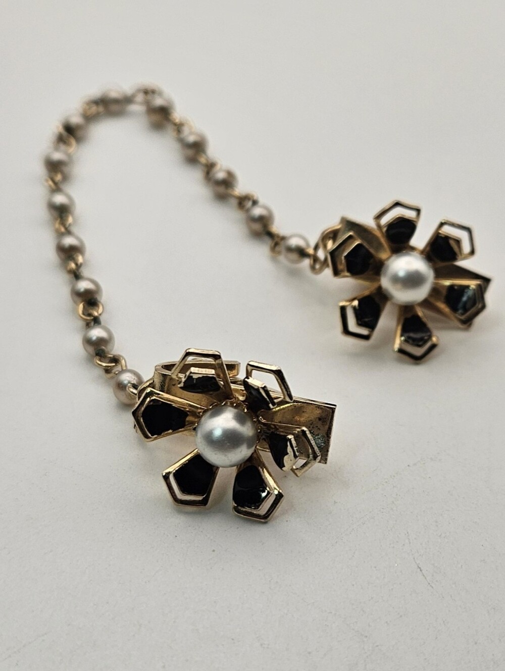 Vintage Sweater Guard Clip Gold Tone Black Enamel Faux Pearl Flower Pat Pend